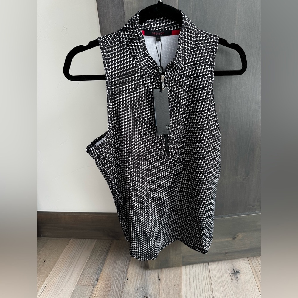 Silky soft Greyson black and white “wolvestooth” print sleeveless golf top.